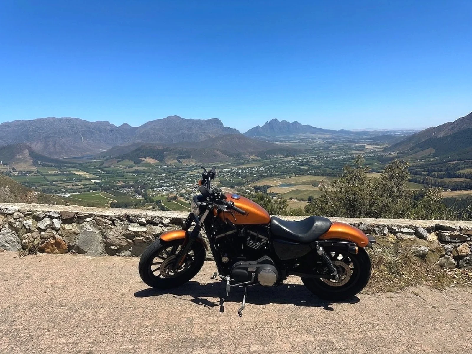 Motorcycle overlooking the Cape vineyards and mountains